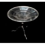 A silver tazza with pierced and fretted decoration on a baluster turned column and triform base,