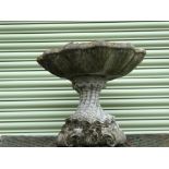 A reconstituted stone bird bath modelled as a clam shell, height 46cm.