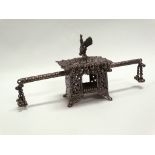 A Chinese circa 1900 white metal model of a sedan chair, the finial modelled as a cockerel,