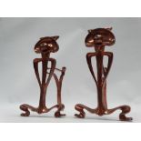 Art Nouveau - A pair of cast copper fire dogs of tendril, sphere and stylised arch shape, height