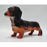 Beswick - A black and tan dachshund, height 13.5cm, length 22cm.