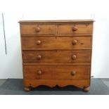 A Victorian stripped pine chest - Two short and three graduated drawers with shaped apron and