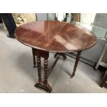 Mahogany Sutherland table - A late Victorian oval twin turned columns, drop flap table with brass