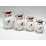 Coalport jugs - A set of four graduated jugs, 'The Caughley Mask-Head Jug', gilt and floral