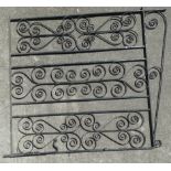 A pair of black painted wrought iron garden gates, each height 143cm, width 121.