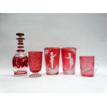 Mary Gregory etc - A pair of cranberry glass beakers with white enamel decoration, a clear handled