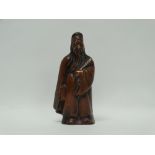 A cast hollow bronze figure of a Chinese sage/immortal holding a folding fan, height 14.3cm.