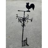 A black painted wrought iron wind vane modelled as a chicken, height 132cm, width 47cm.
