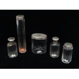 Five Victorian silver and white metal topped glass dressing table bottles, largest height 17.7cm.