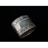 A Russian silver napkin ring decorated with two bands of geometric pattern, weight 48.5g.