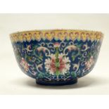 Chinese bowl - A blue ground bowl decorated with flowers and scrolling tendrils, the rim with a band