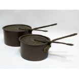 19th century copper saucepans - A graduated pair of planished copper lidded saucepans with bronze
