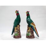 20th century Chinese - A pair of polychrome game cocks perched on rocky outcrops, impressed marks to