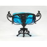 German WMF glass - A base metal and teal glass tazza on a four footed stand, marked to base,