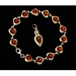 A silver and amber bracelet, length 18.5cm, together with a matching pendant.