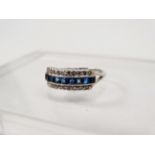 Platinum, sapphire and diamond ring - A band of sapphires flanked by chip set diamonds on a platinum