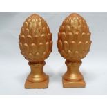 Pine cone finials - A pair of reconstituted painted stone finials formed as pine cones on turned