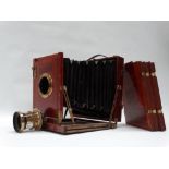 A whole-plate Rayment's Patent mahogany field camera by Perken, Son & Rayment, London with square-