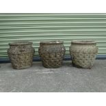 Three reconstituted stone planters with geometric design, height 31cm, depth 32cm.