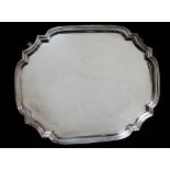 A silver tray of large lozenge shape raised on four shaped feet, Birmingham 1937, maker's mark for