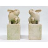 Chinese Scroll Weights - A pair of 19th century opposing carved green flecked hardstone rabbits