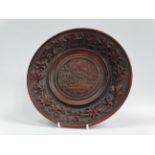 Black Forest - A circa 1900 carved wooden plate with Castle of Chilton to centre and Edelweiss