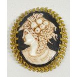 Cameo - A gilt metal laurel chaplet bordered black hard ceramic oval with bust head in profile of