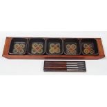 Denby - A teak holder containg five Denby squared serving dishes, together with four Danish