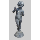 Garden Statuary - A lead putti standing on a mound, height 57cm.