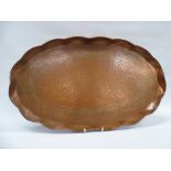 Arts and Crafts Copper Tray - A large oval tray with wavy rim decorated with a scrolling tendril and