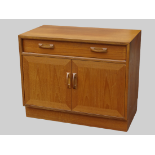 G-Plan Red - A pair of teak small sideboards, each having one long drawer over two cupboard doors,