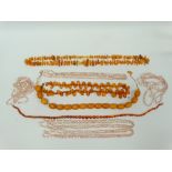 Faux Amber and Freshwater Pearls - Three faux amber necklaces, lengths 53cm, 64cm and 92cm, a