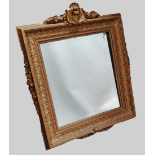 Wall Mirror - A circa 1900 gilt mirror with bevelled glass, crested top and applied straight swag