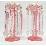Victorian Table Lustres - A pair of pink glass gilt decorated table lustres, with white enamal
