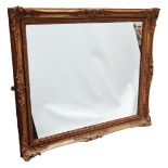 Wall Mirror - A mid 20th century gilt framed wall mirror with Rococo style moulding, height 80.