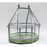 Terrarium - A terrarium with a long octagonal angled top and lead base, with green stained glass
