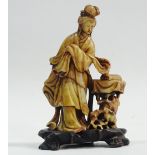 Signed Soapstone - An oriental soapstone figure of a lady and a rabbit, calligraphy to base, on a