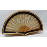 Cased Silk Fan - A circa 1900 sixteen stick silk fan with hand painted butterfly and hedgerows