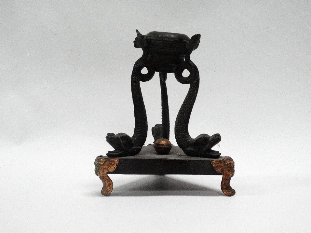 Regency Candle Stand - A triform cast bronze and gilt metal candle stand modelled as three