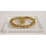 9ct Gold Bracelet - A 9ct gold curb link braclet with 9ct gold padlock clasp, weight 31.1g.