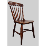 A 19th Century Gothic Side Chair - A Devon made elm seated turned stickback chair with saddle shaped