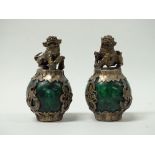 Tibetan Silver Fo Dogs - A pair of Fo dogs representing fertility and wisdom atop green stone