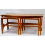 Mid Century Teak - A coffee table with two orphan occasional tables, with shaped legs and
