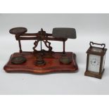 Postage scales, carriage clock - A set of imperial brass postage scales with five weights on a