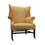Wing chair in the Georgian taste - A yellow upholstered wing chair on square legs joined by an H