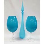 Blue glass - A tall pale blue flask with slender pointed stopper, height 79.5cm, together with a
