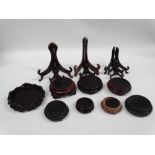 Chinese wooden stands - A collection of eight circular hardwood stands, largest diameter 17cm and