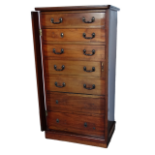 Wellington chest - A late Victorian/Edwardian seven drawer walnut chest with two side locking panels