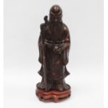 Chinese bronze figure - A figure of an elderly bearded gentleman holding a stick and a fruit, on a