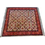 Indo Persian rug - A hand knotted Indo Persian wool rug with three borders and floral motifs, with